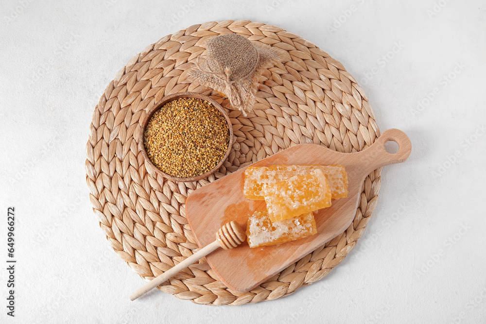 Composition with honey, combs and bee pollen on light background