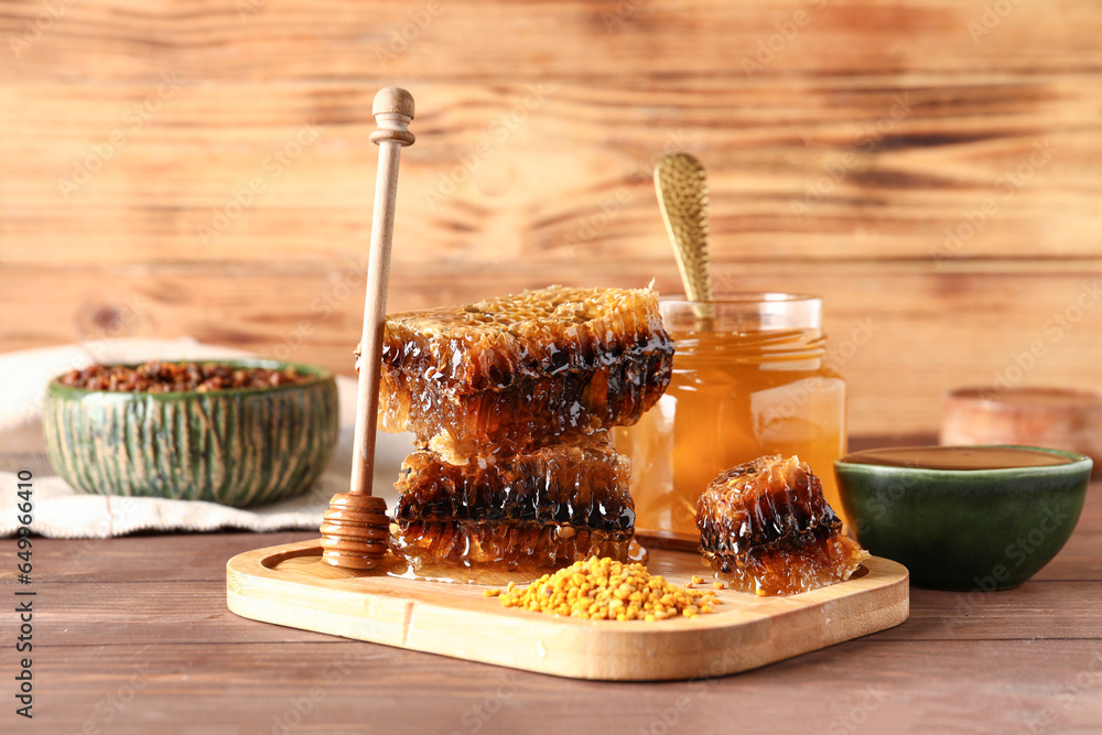 Sweet honey, combs and bee pollen on wooden background