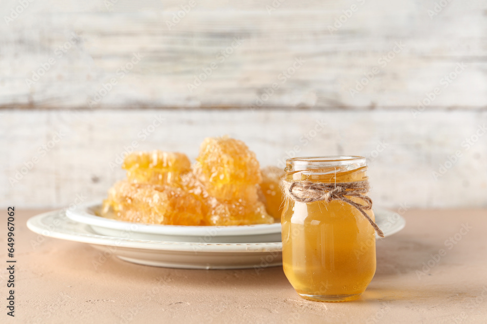 Jar with sweet honey on table