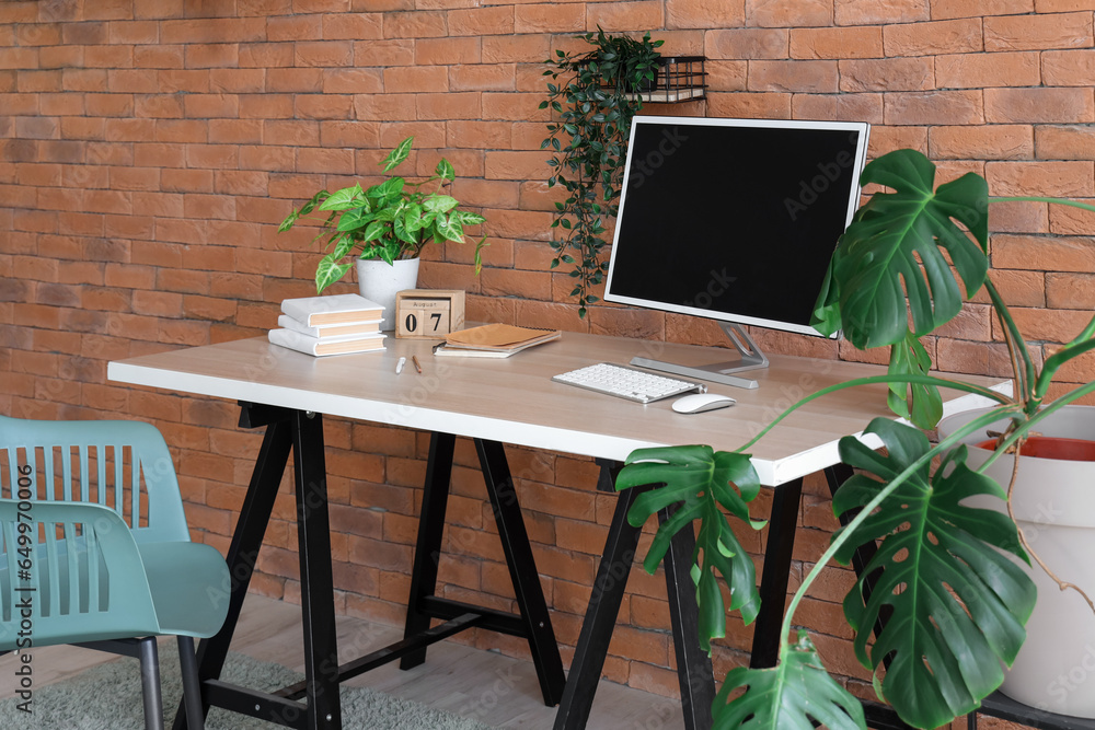 Interior of office with modern workplace and houseplants