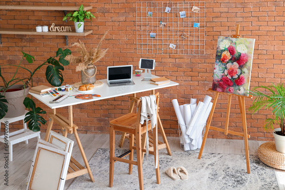 Interior of studio with artists workplace and drawing supplies