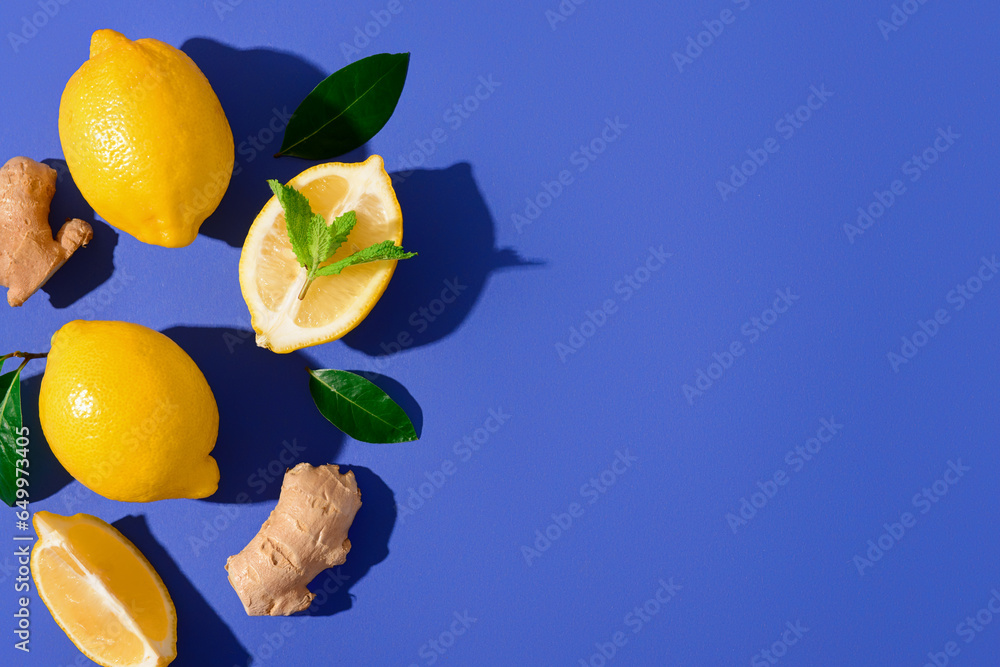 Fresh lemons with mint ginger roots on blue background