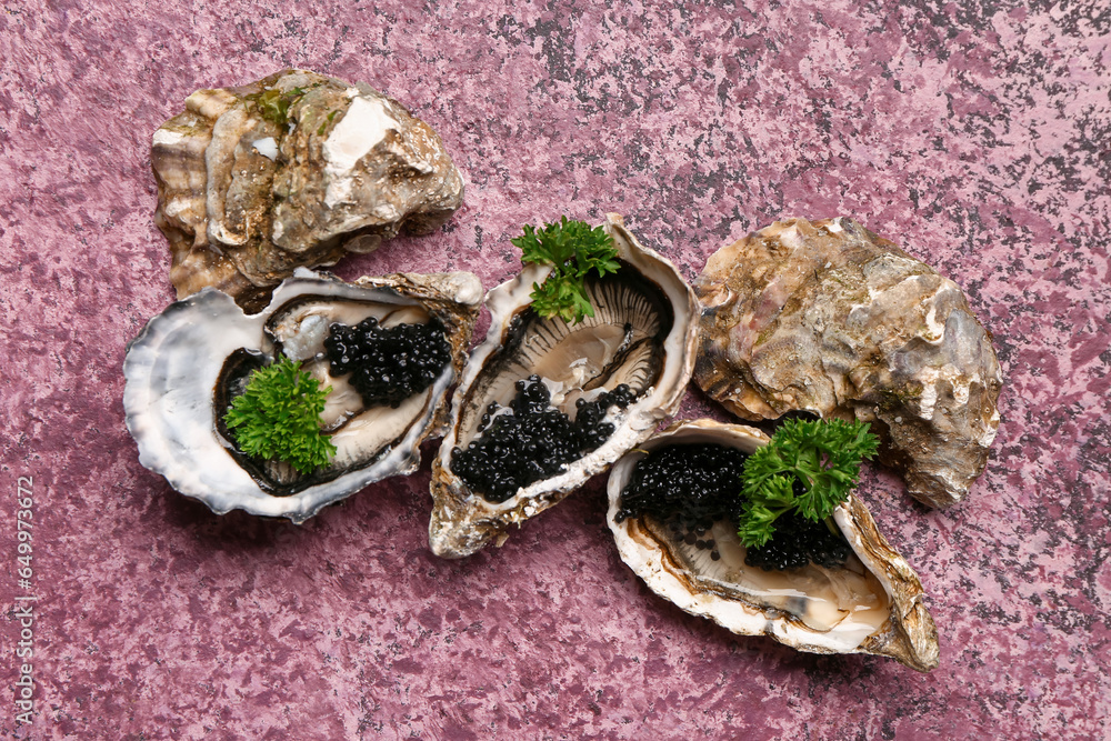 Tasty oysters with black caviar on purple background