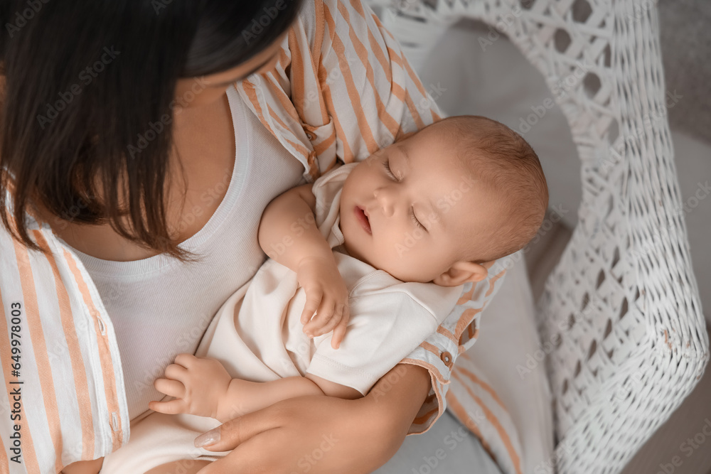 Young woman with her sleeping baby in bedroom, closeup