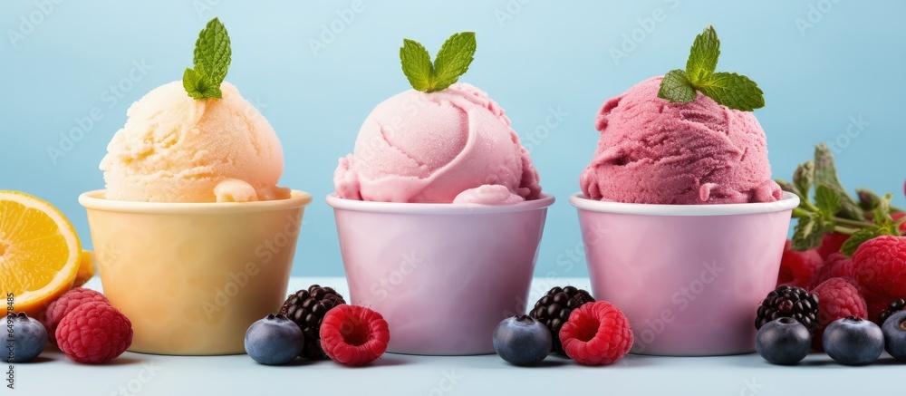 Frozen yogurt or ice cream with lemon mango and blueberries a healthy summer dessert displayed on a pink background with copy space