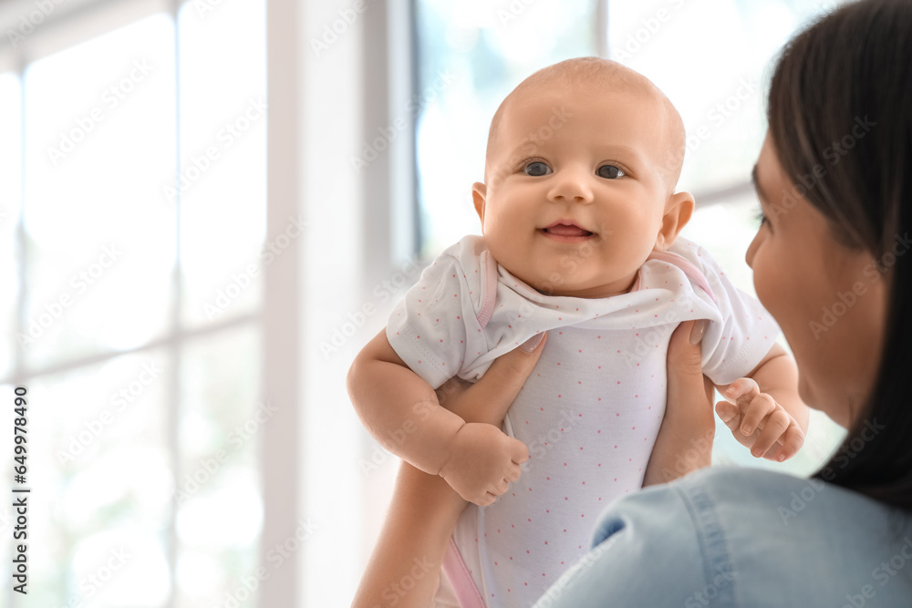 Young woman with her baby at home, closeup