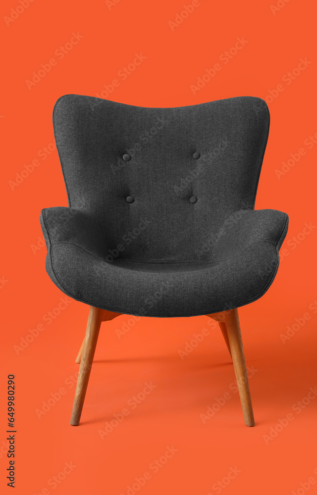 Black armchair on red background