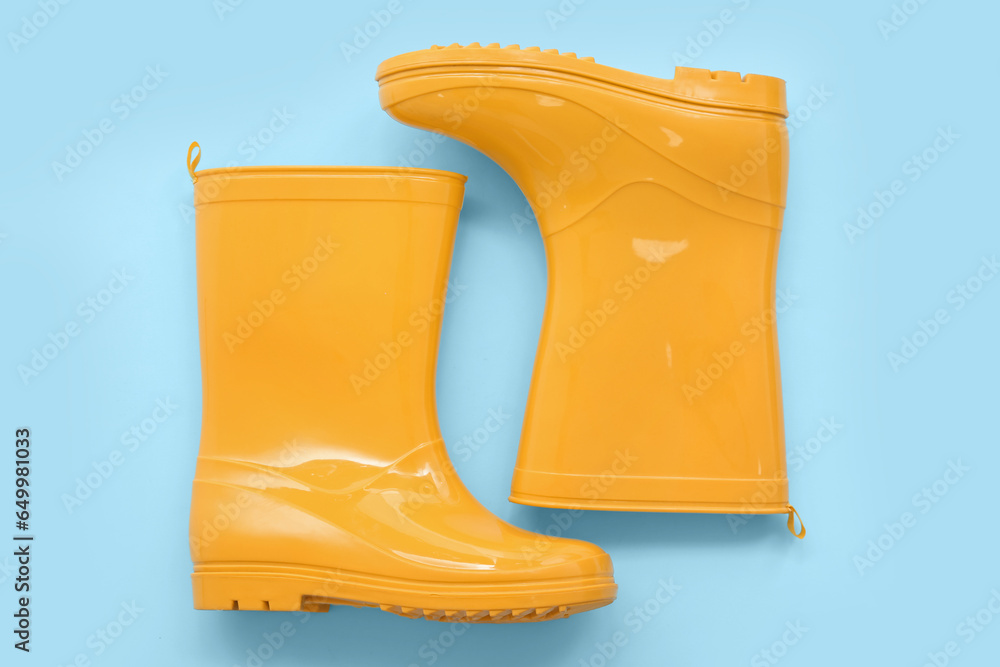 Yellow gumboots on blue background