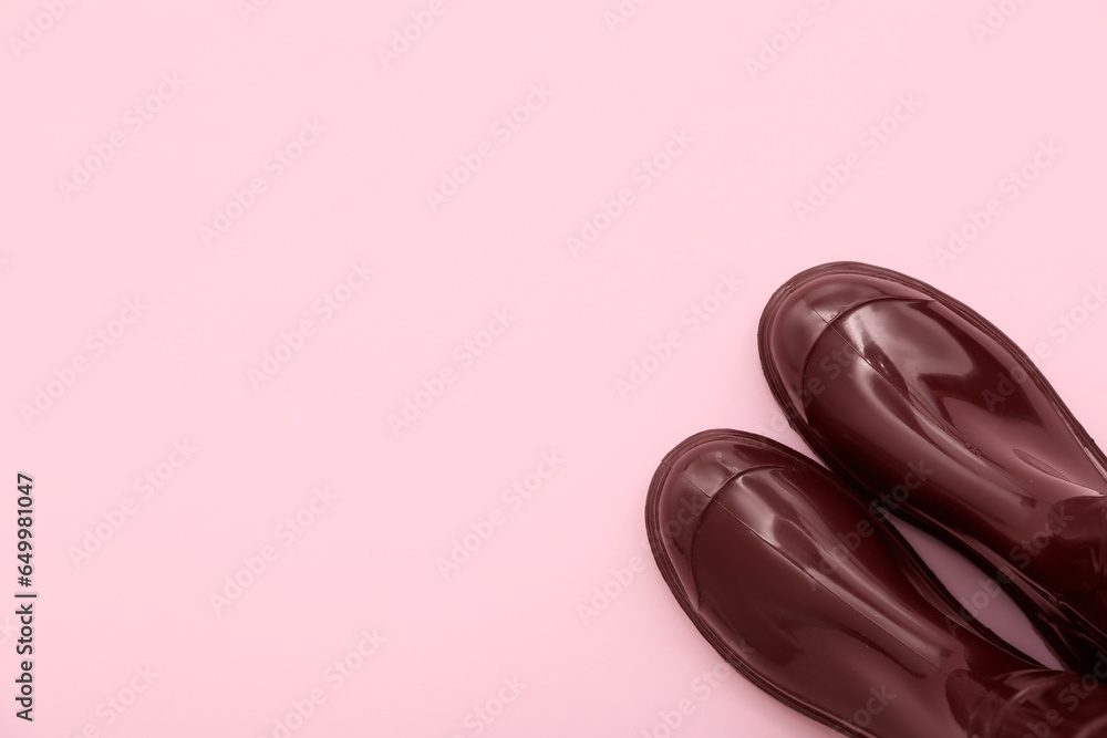 Red gumboots on pink background