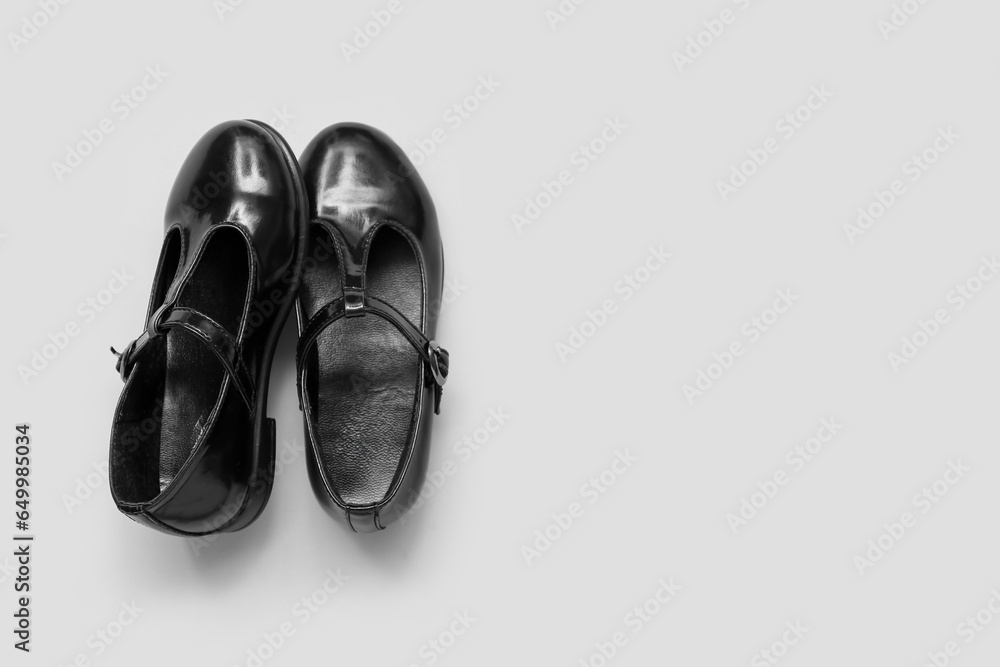 Pair of stylish childs shoes on grey background