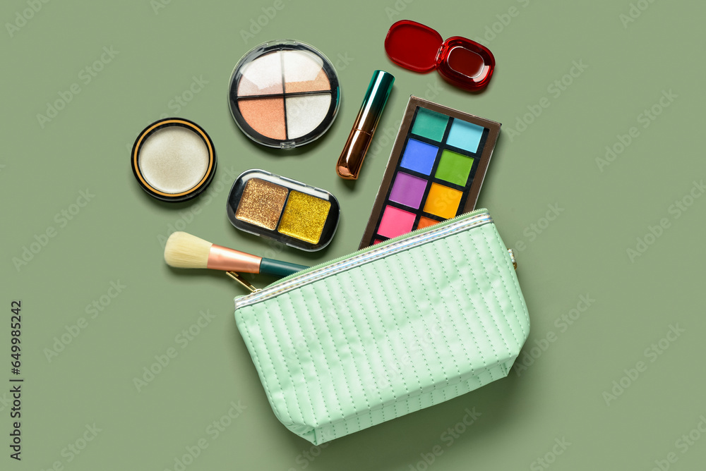 Bag with different decorative cosmetics on green background