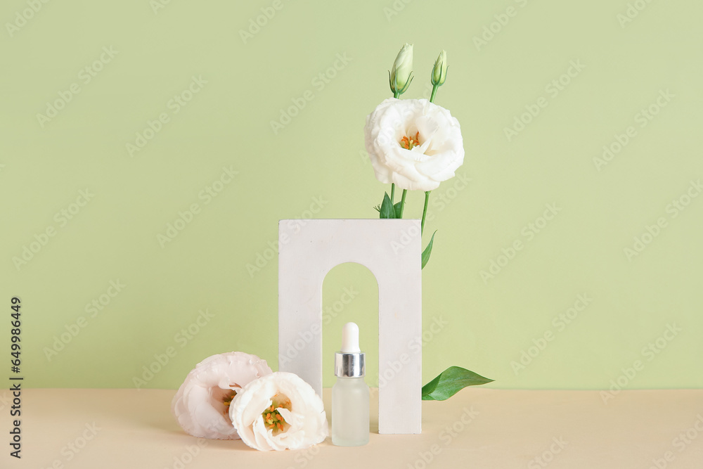 Composition with bottle of essential oil, plaster podium and beautiful eustoma flowers on color background