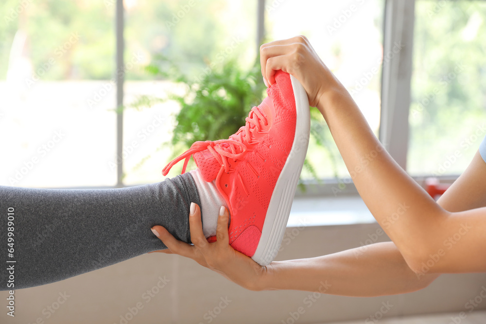 Mature woman training with therapist in rehabilitation center, closeup