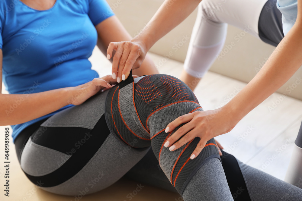 Mature woman training with therapist in rehabilitation center, closeup