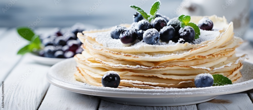 Vegan chickpea crepes with gluten free flour oat milk and blueberries on a wooden table