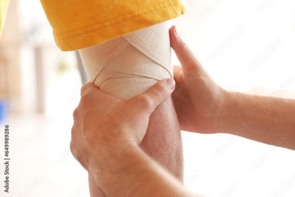 Mature man training with therapist in rehabilitation center, closeup