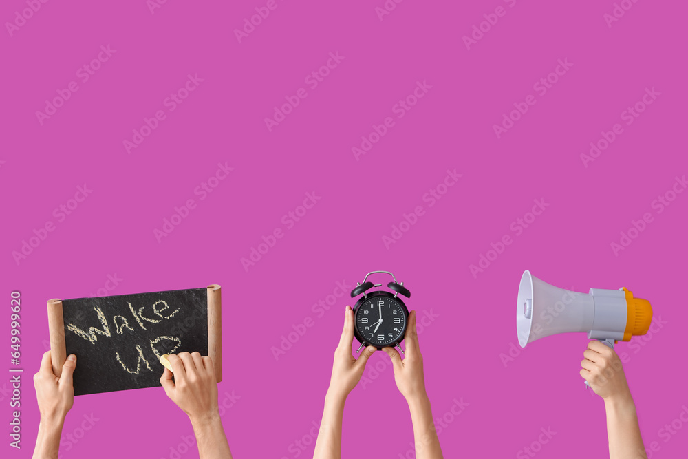 Hands holding alarm clock, megaphone and board with text WAKE UP on purple background