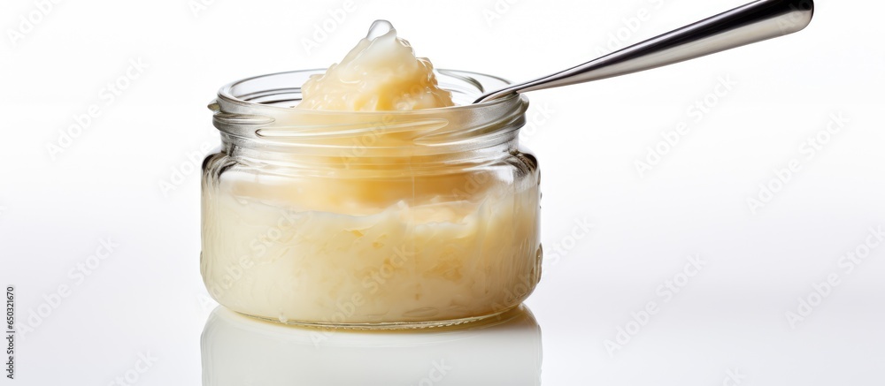 Baby pureed in jar on white background using a spoon