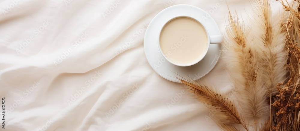 Breakfast in a cozy home drinking cappuccino with pampas grass and a white cup creating an aesthetic flat lay with wallpaper