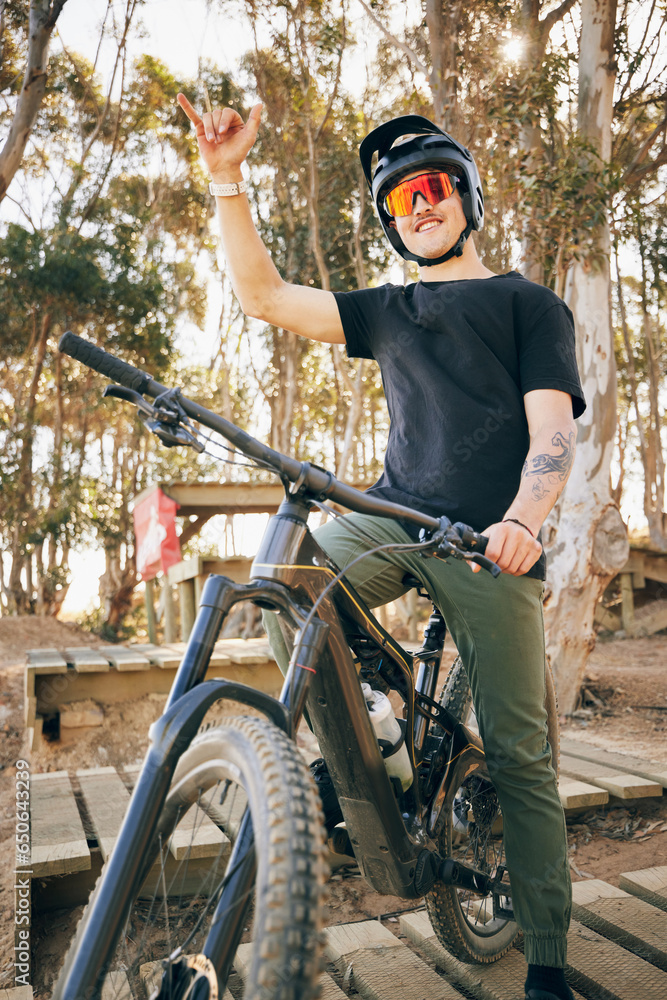 Bike, adventure and hand gesture with a sports man outdoor in a park for off ride riding during a race. Fitness, exercise and bicycle with a young athlete training for a competition in the forest