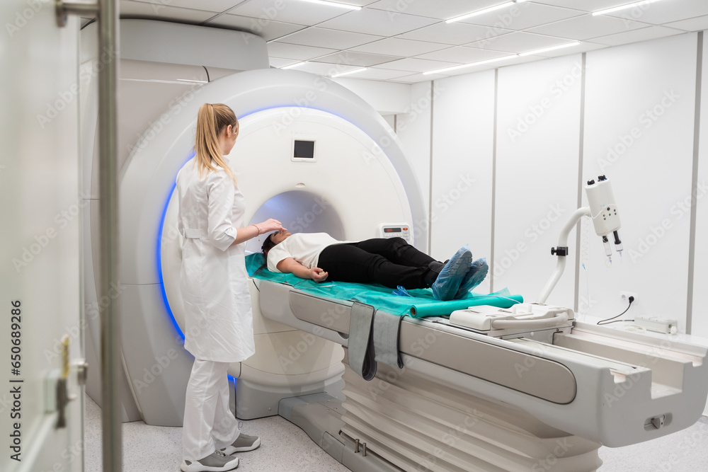 Medical CT or MRI Scan with a patient in the modern hospital laboratory. Interior of radiography department. Technologically advanced equipment in white room. Magnetic resonance diagnostics machine