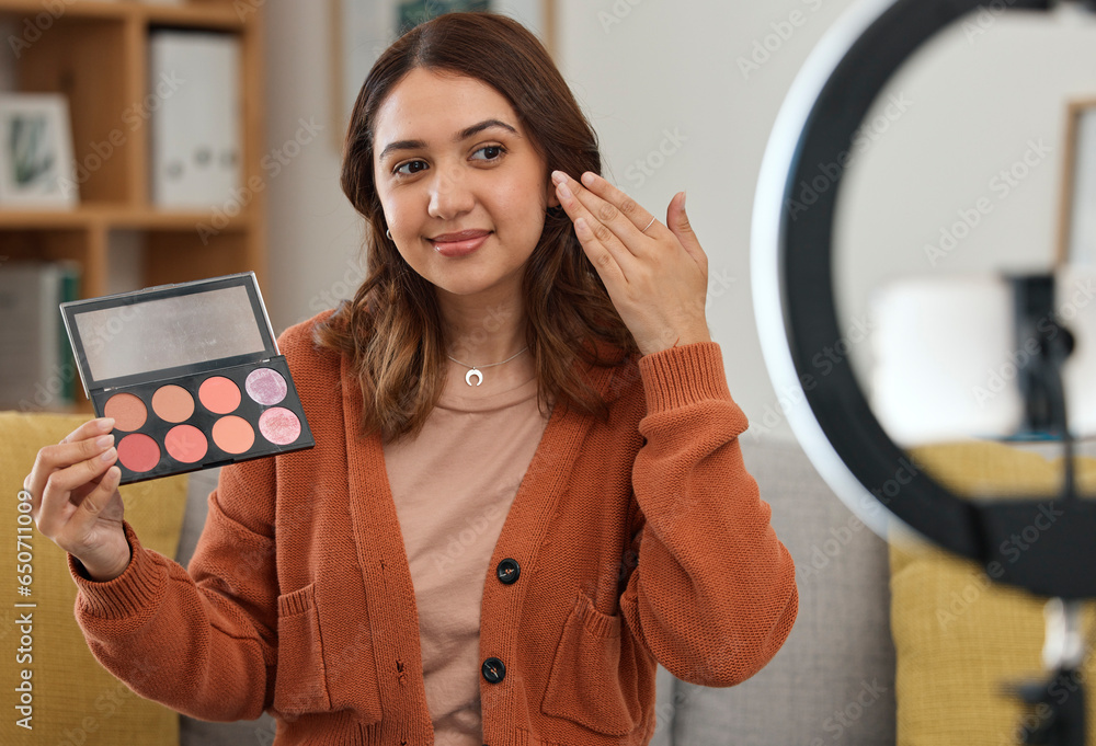 Streaming, makeup and review with a woman influencer in her home to broadcast live content to viewers. Social media, product or tutorial with a young brand ambassador in the living room for cosmetics