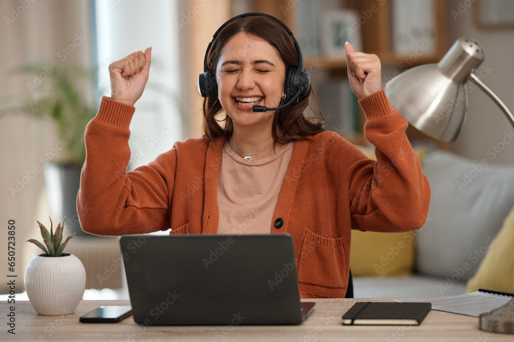 Woman, headset and laptop in celebration at home with goal, achievement and victory. Female person, consultant or employee with arms up in happiness on video call, telemarketing or support to clients