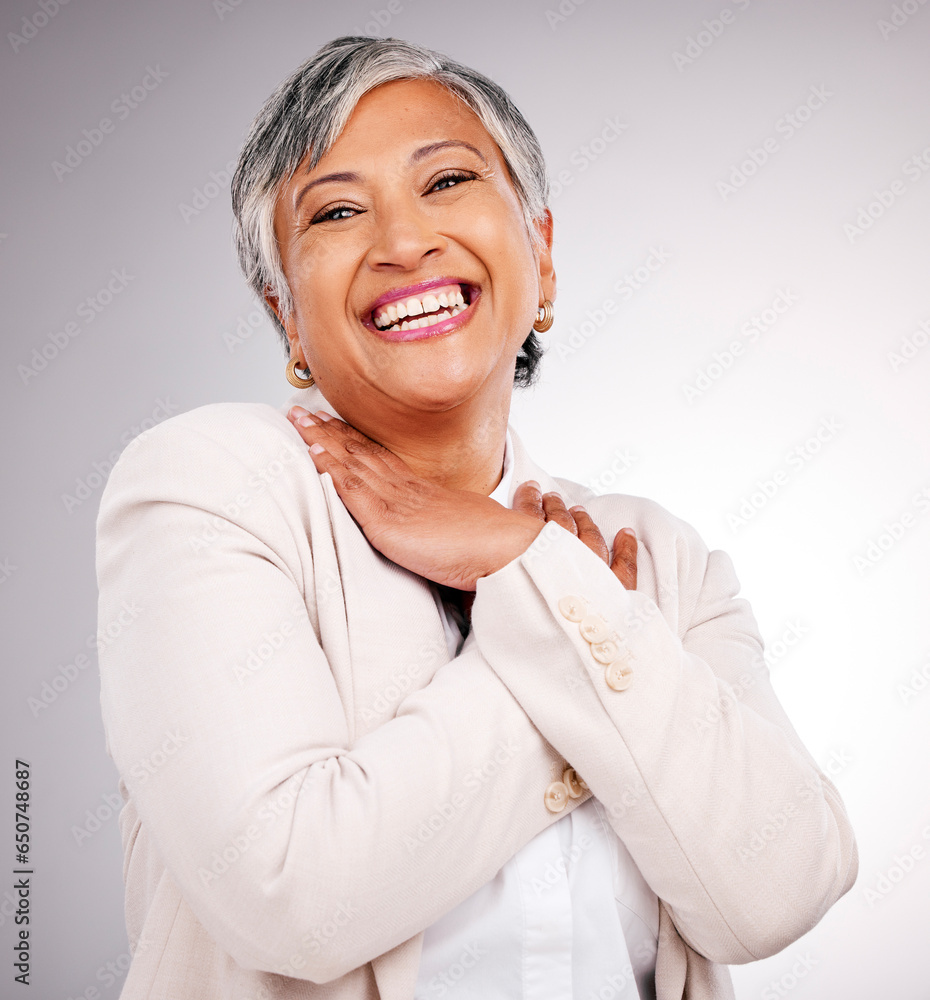 Portrait, happy and a mature business woman laughing in studio on a gray background for executive or growth. Comic, smile and face frame with a corporate professional looking confident in a suit