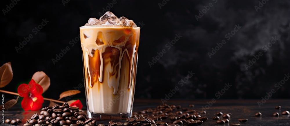 Iced latte coffee with milk and coffee beans on marble table