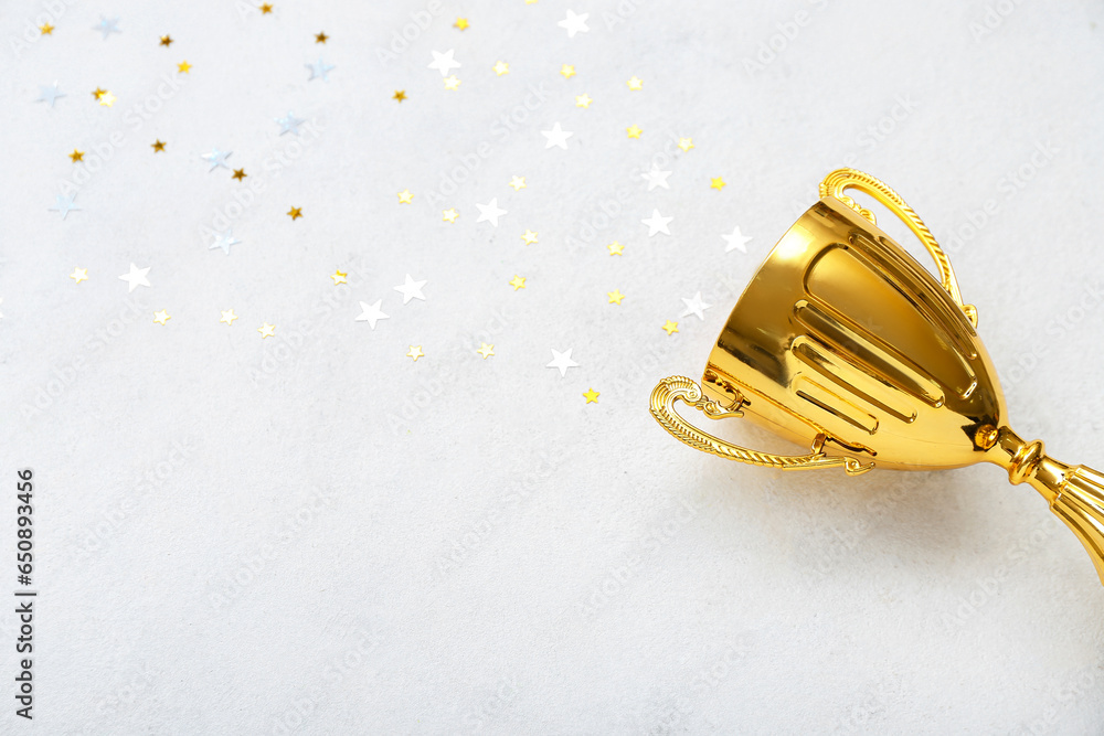 Gold cup with stars on white background