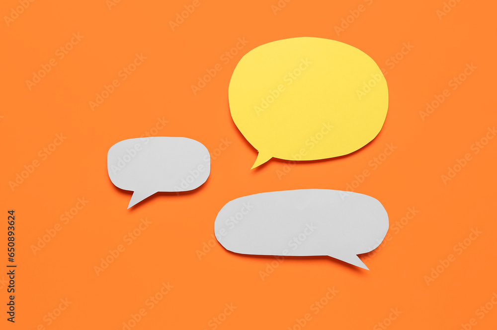 Blank paper speech bubbles on orange background