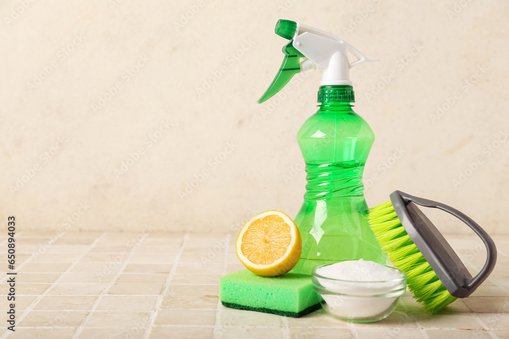 Bowl of baking soda and cleaning supplies on light tile table