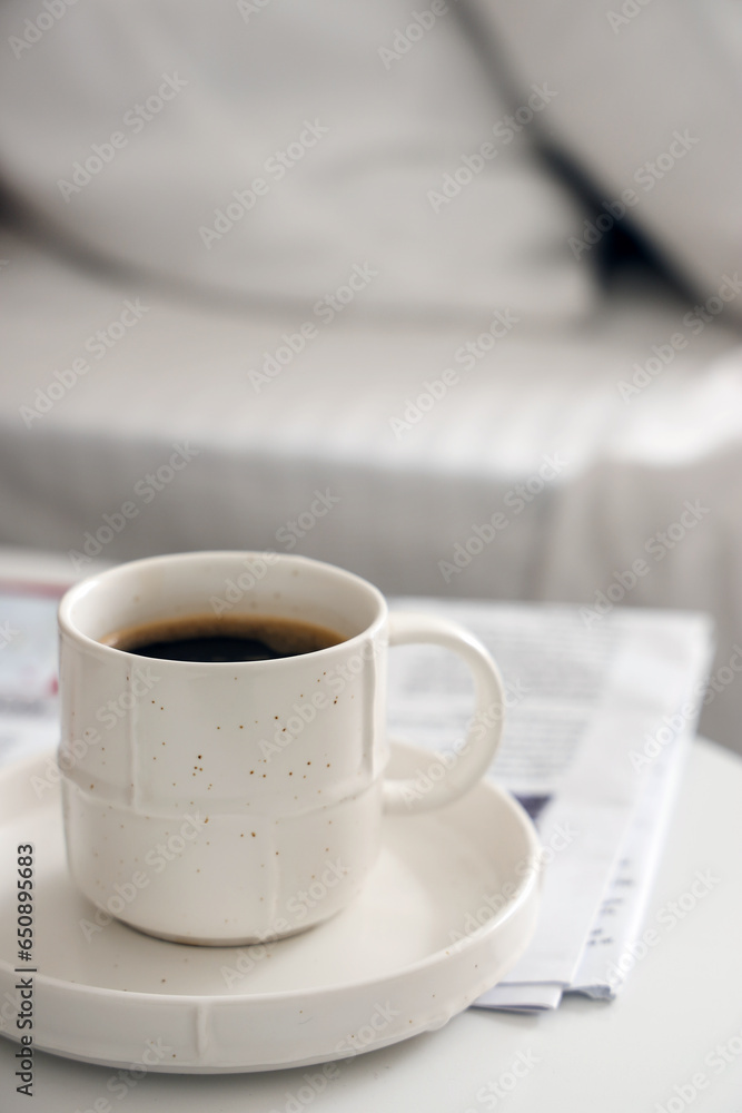 Saucer with cup of coffee on table, closeup