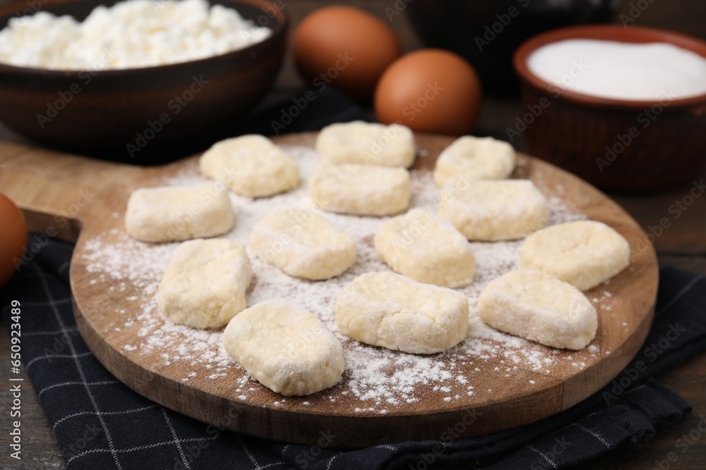 Making lazy dumplings. Board with cut dough and ingredients on wooden table, closeup