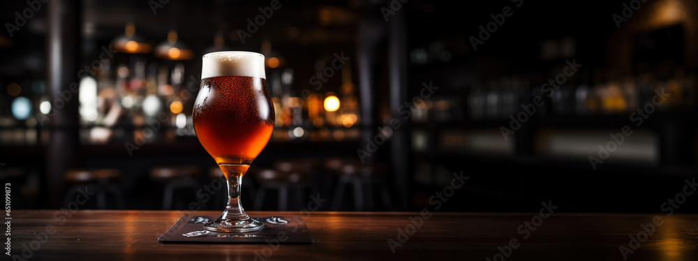 Snifter glass of light beer on bar table in a dark pub with copy space. Generative AI