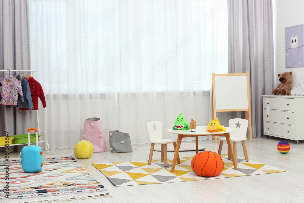 Child`s playroom with different toys and modern furniture. Stylish kindergarten interior