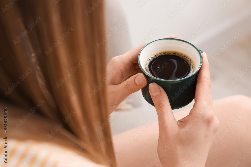 Woman holding cup of delicious coffee, closeup