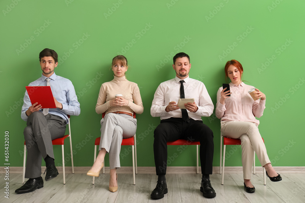 Young applicants waiting for job interview in room