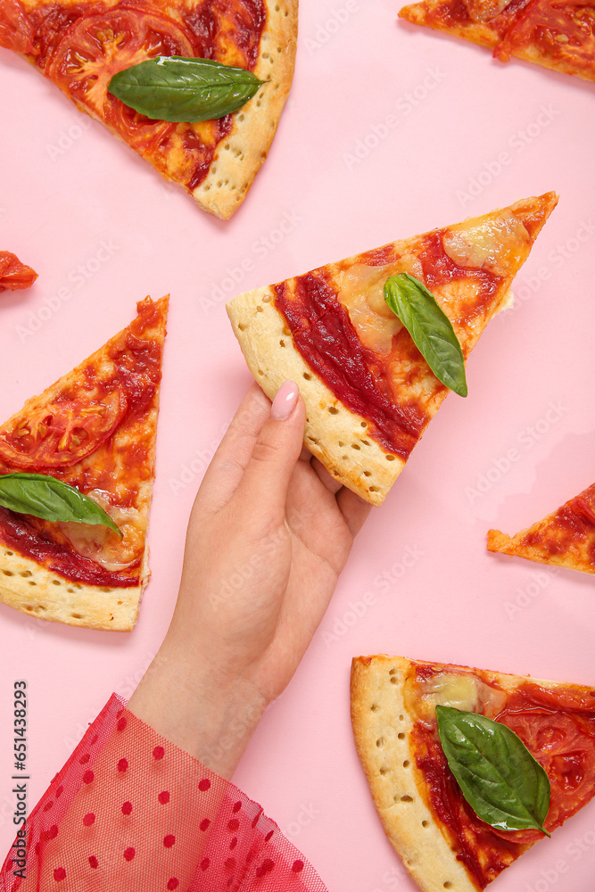 Woman with slices of tasty pizza on pink background