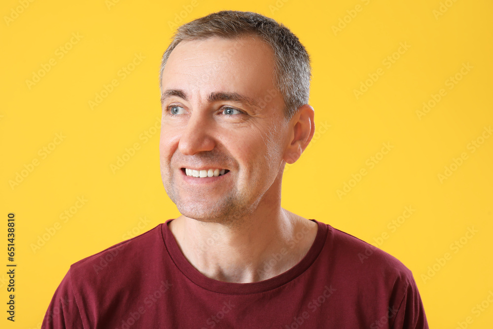 Portrait of happy mature man on orange background