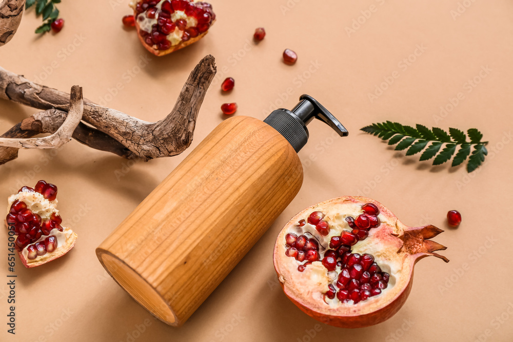 Composition with bottle of cosmetic product, pomegranate and tree branch on color background