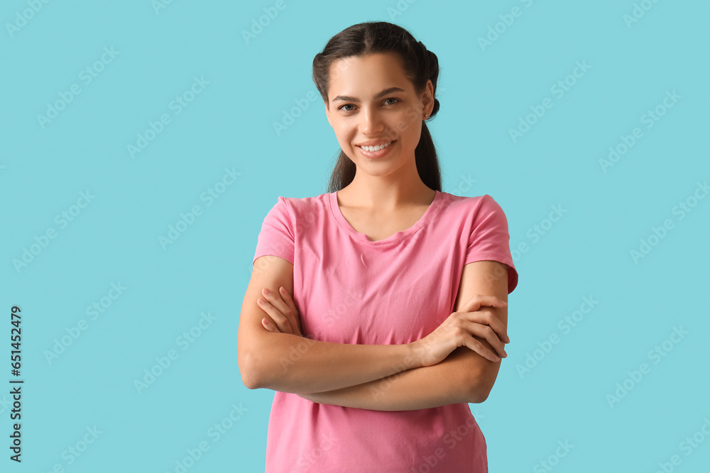 Young brunette woman on blue background