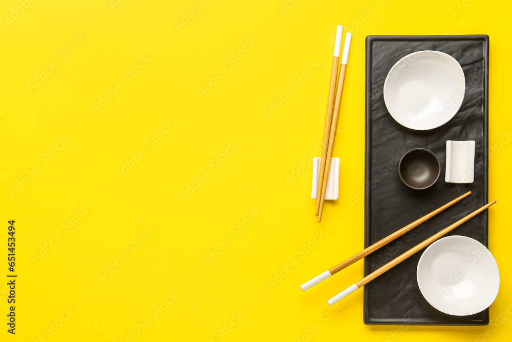 Chinese tableware on yellow background