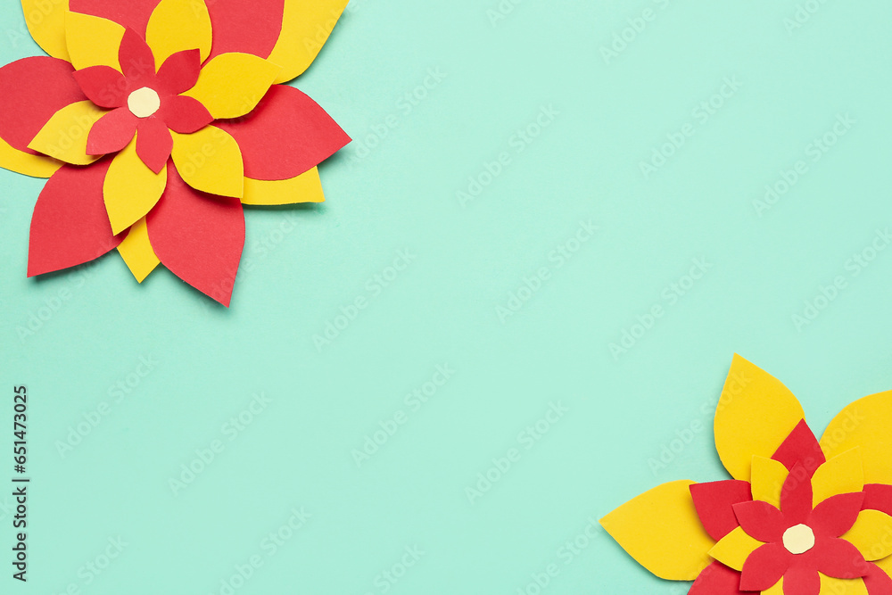 Colorful origami flowers on green background