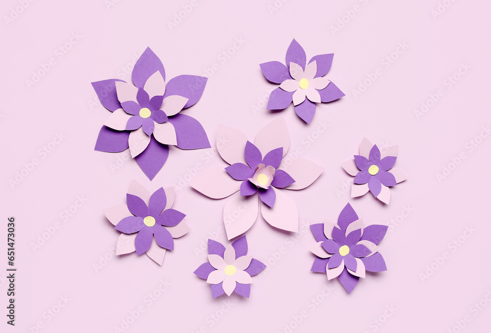 Colorful origami flowers on purple background