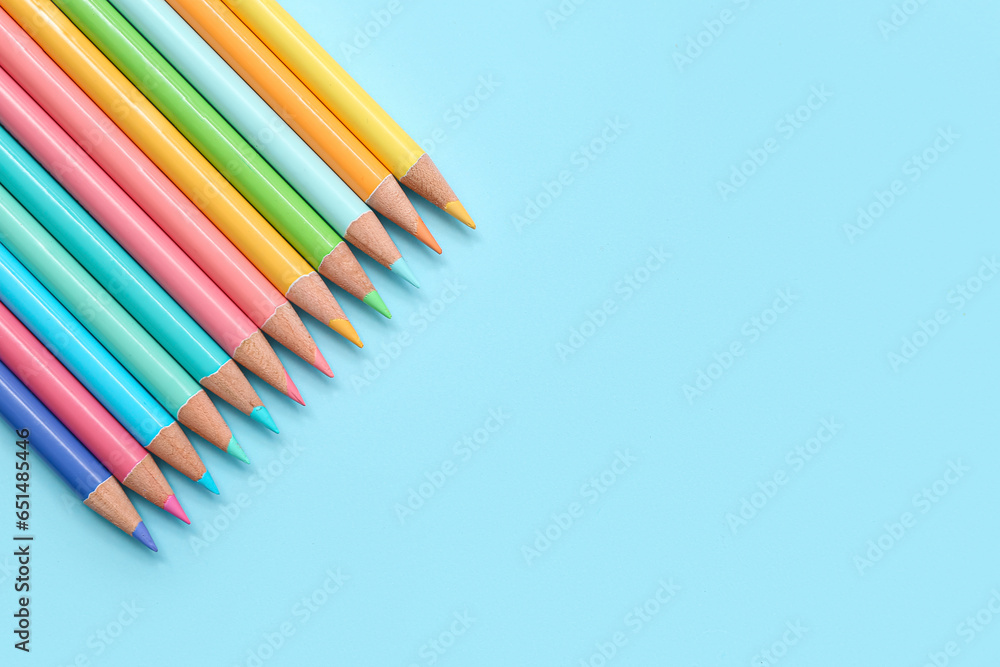 Many colorful pencils on blue background