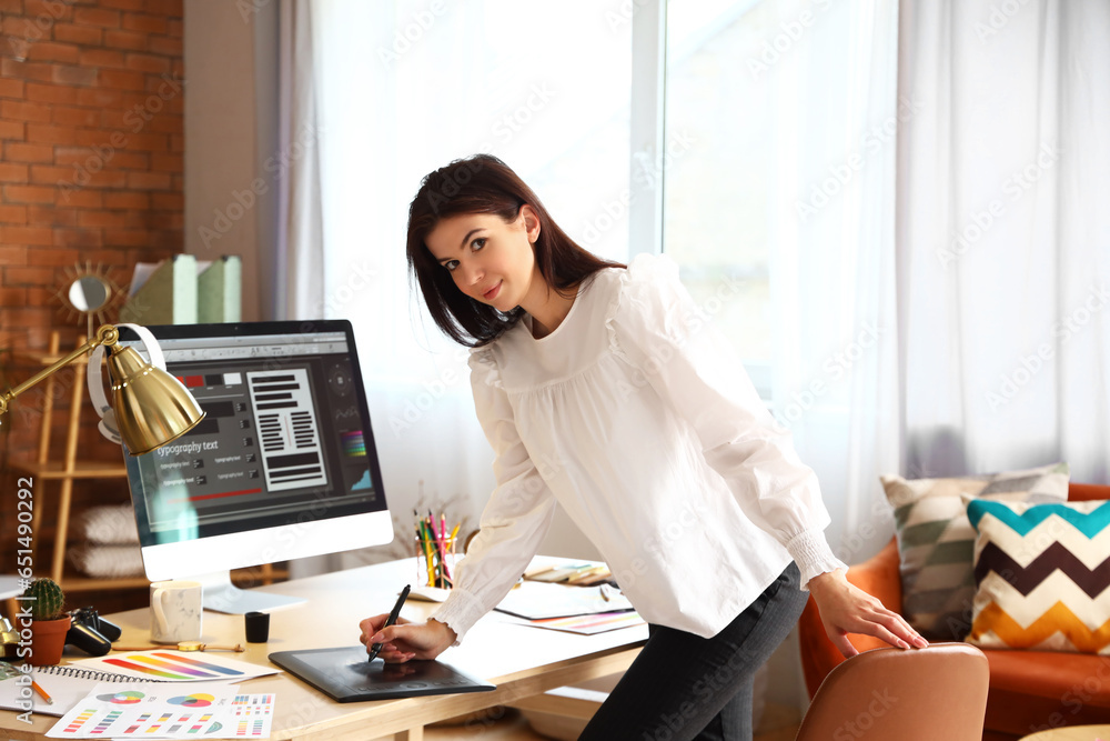 Female interior designer working at table in office