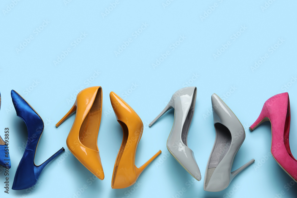 Different stylish high heels on blue background