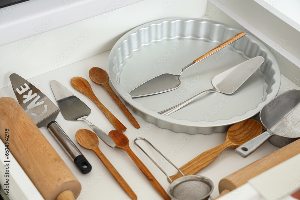 Set of utensils for bakery in drawer at kitchen