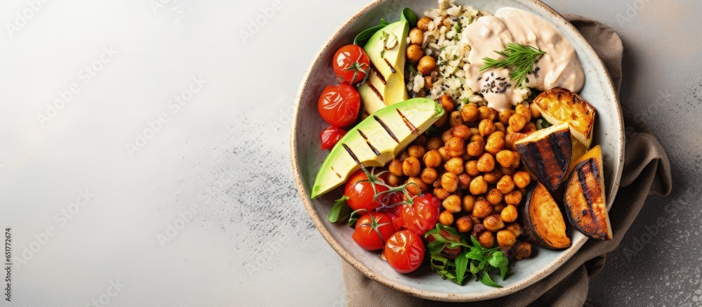 Healthy vegan concept Top view of a Buddha bowl with baked veggies chickpeas hummus and tofu